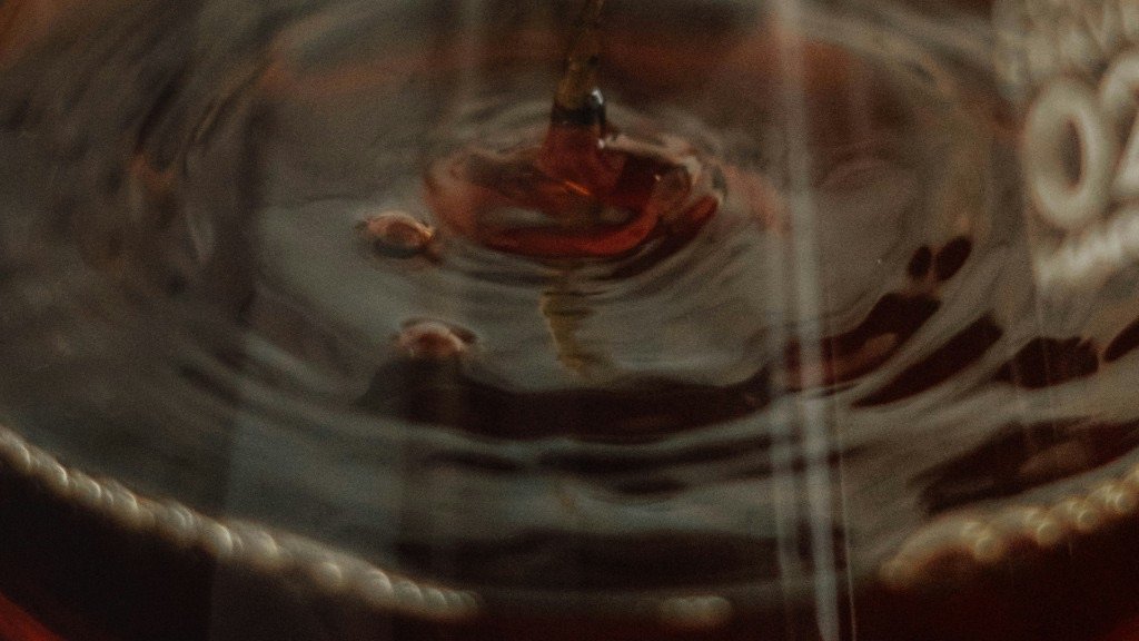 Close-up of dark coffee liquid with ripples.